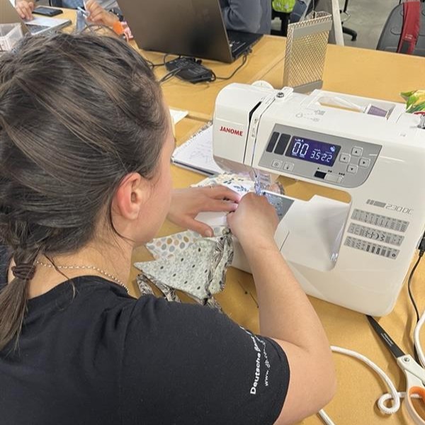 Bethany using a sewing machine.