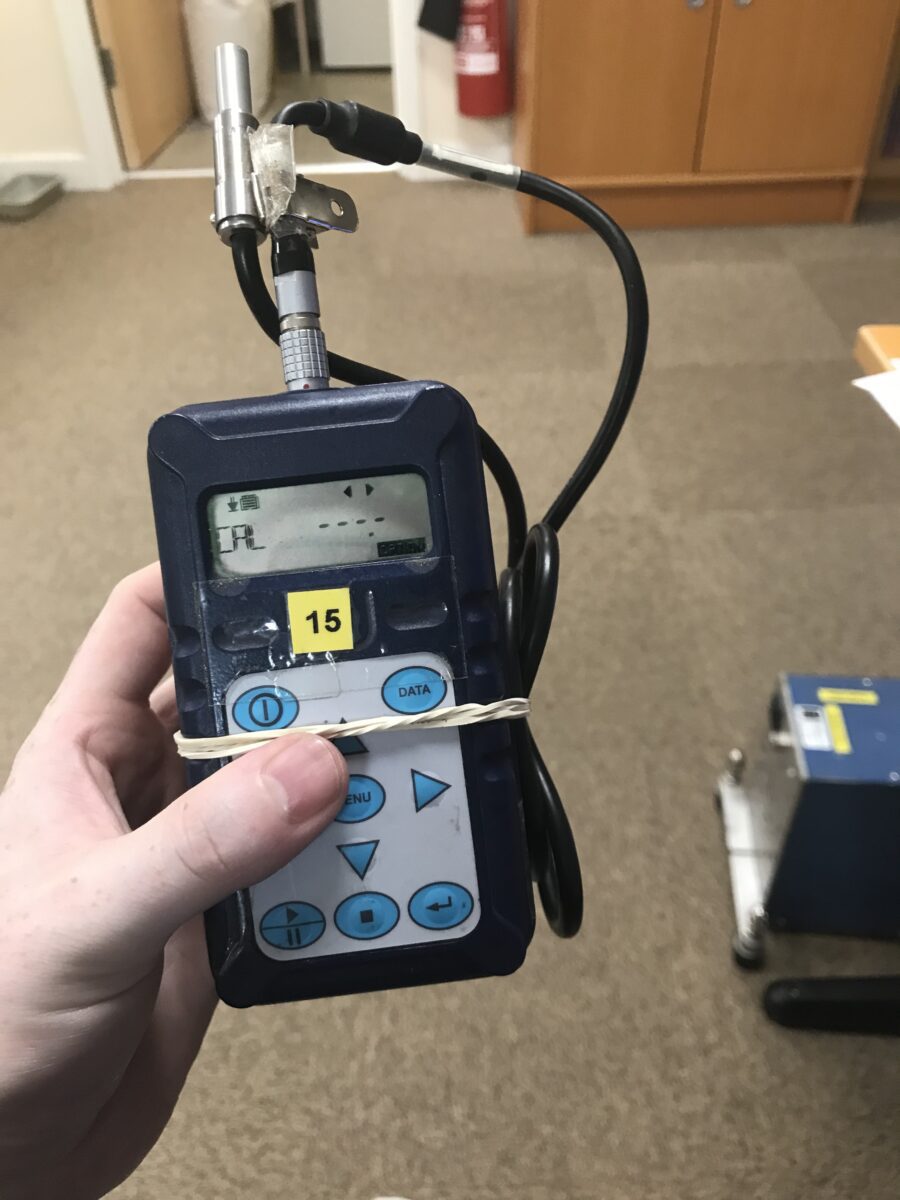 Baden Fitzmaurice using a handheld sound level meter.