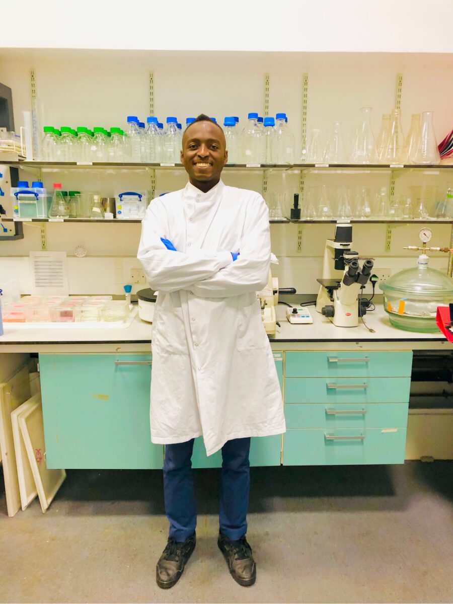 Nana wearing a lab coat, posing for a photo in the lab.