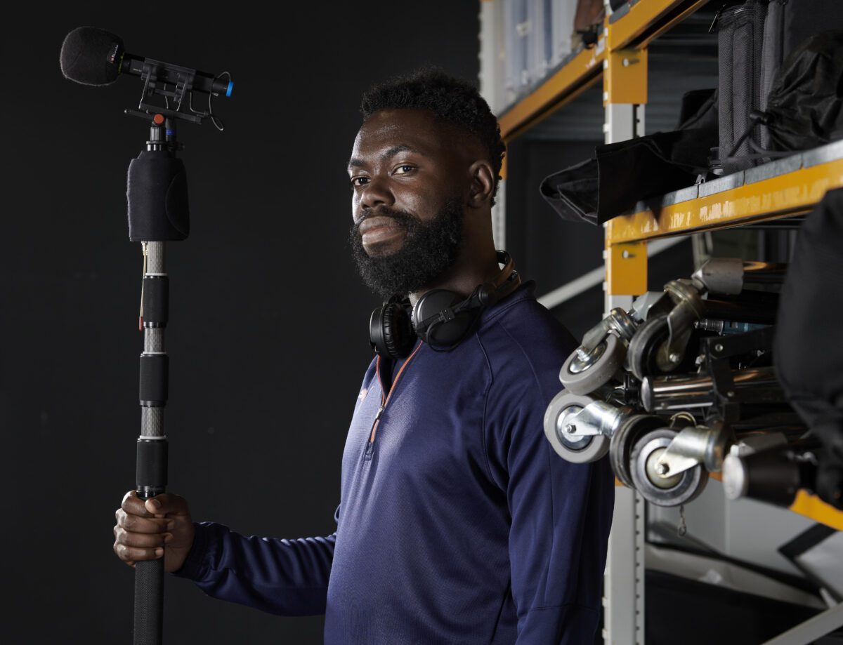 A sound technician holding a boom mic.
