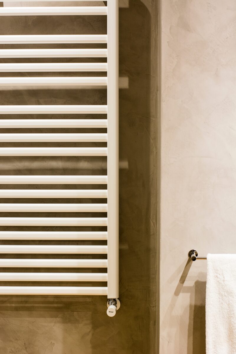 A heated towel rail in a bathroom.