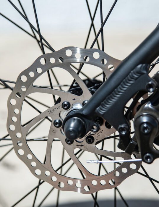Brake disc at the centre of a bicycle wheel.