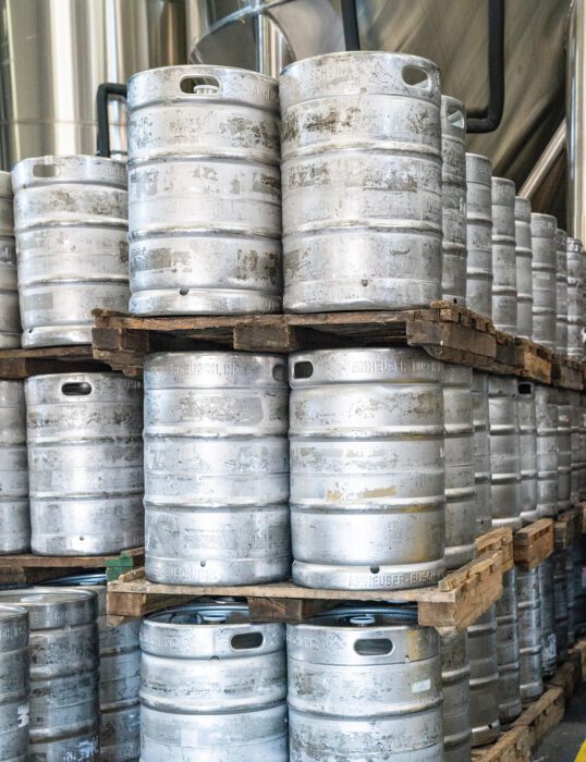 Kegs stacked in a brewery.