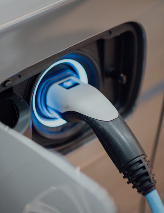 An electric vehicle charger plugged into a car.