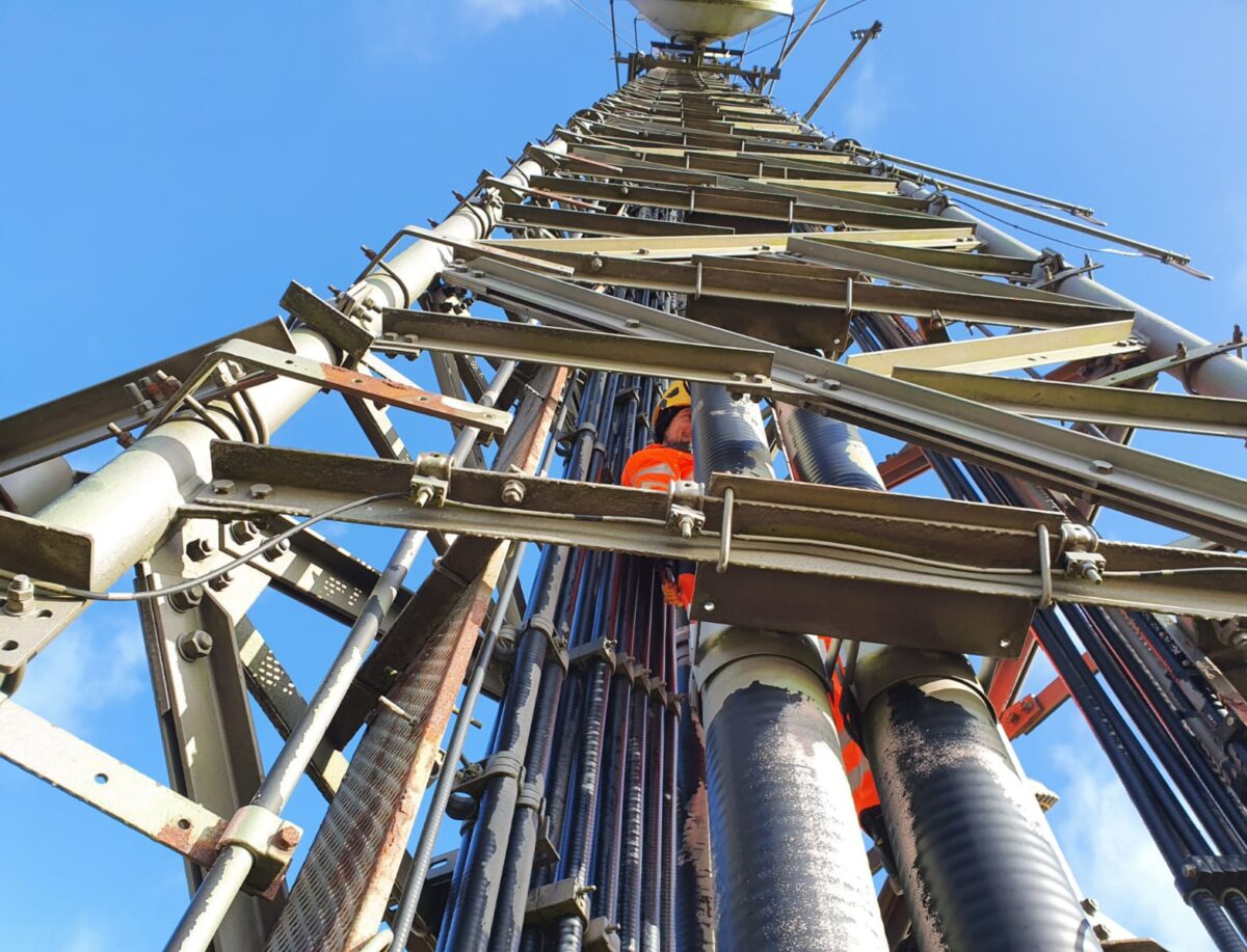 Lewis working at height, inside a mast.