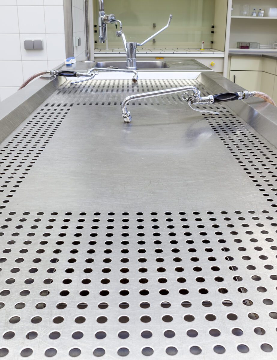 An empty and clean mortuary table.