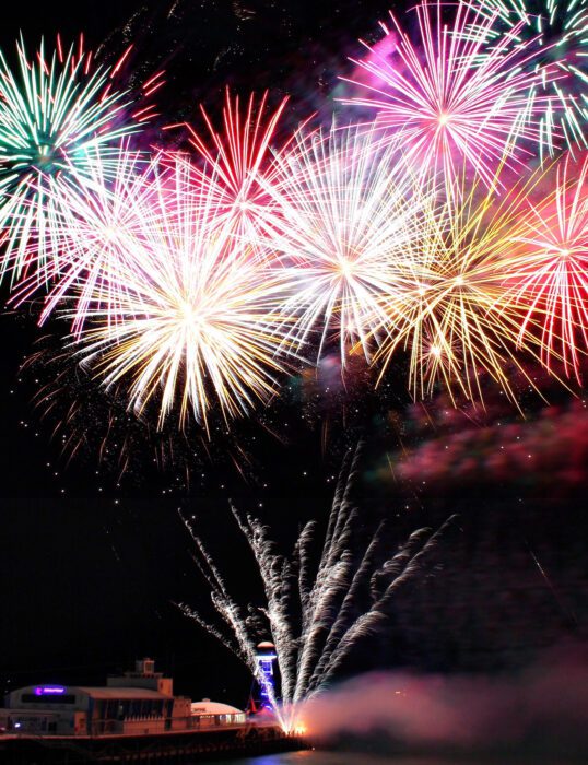 Multiple fireworks exploding in the sky.