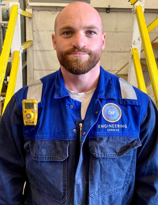 Antonio Morelli at work, wearing overalls.
