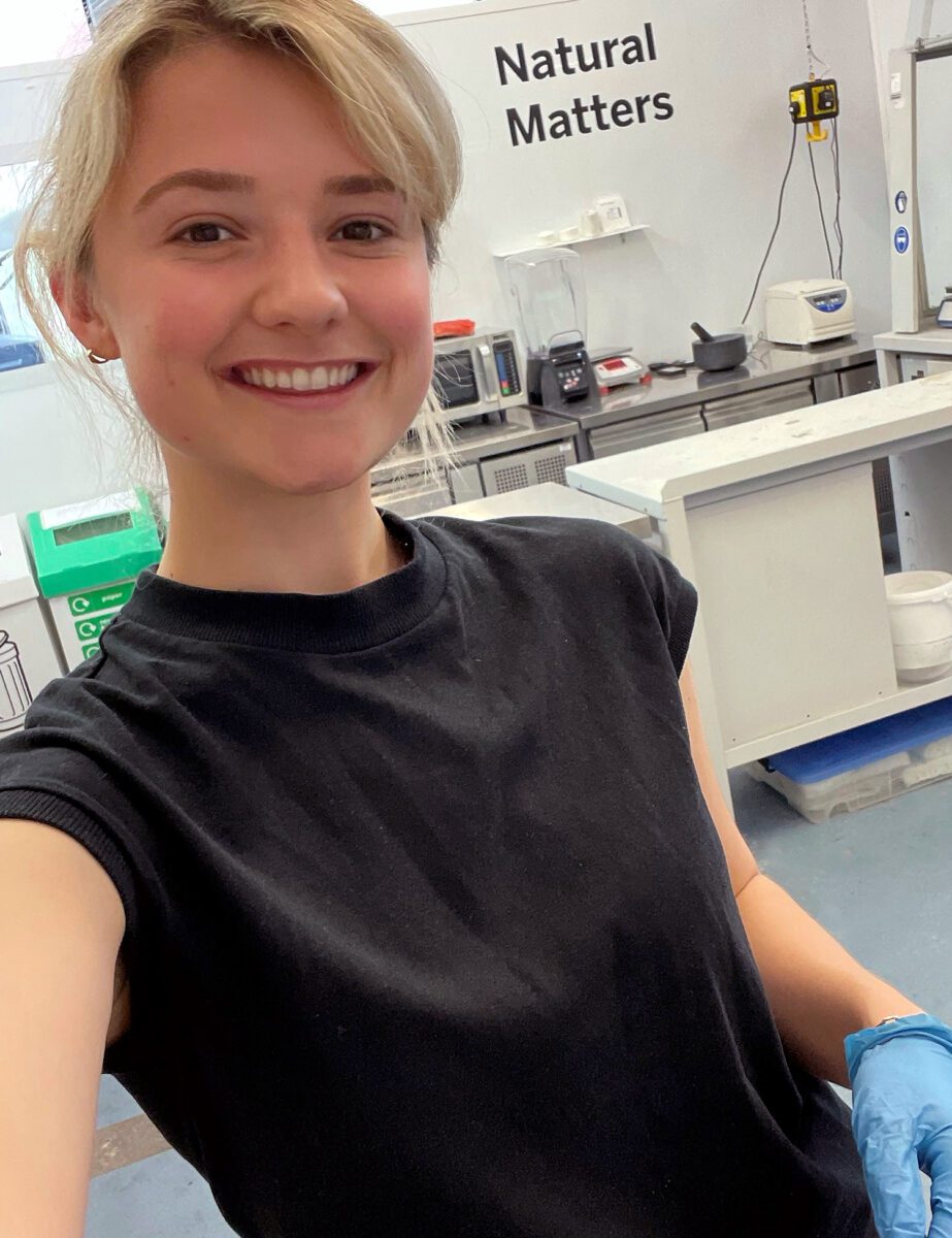Nikki smiling, taking a selfie in the lab.