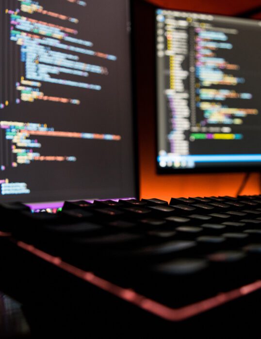 Computer screens showing programming code.