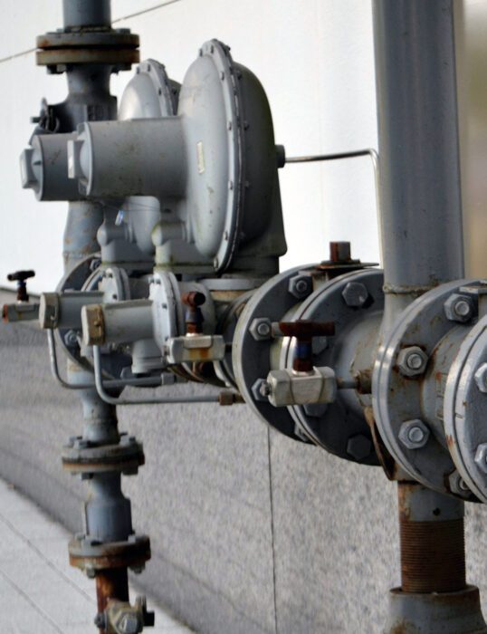 Metal water pipes on the side of a building.