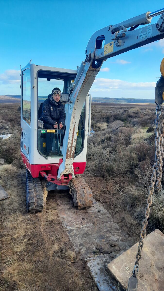 Ambar Hughes operating a digger.