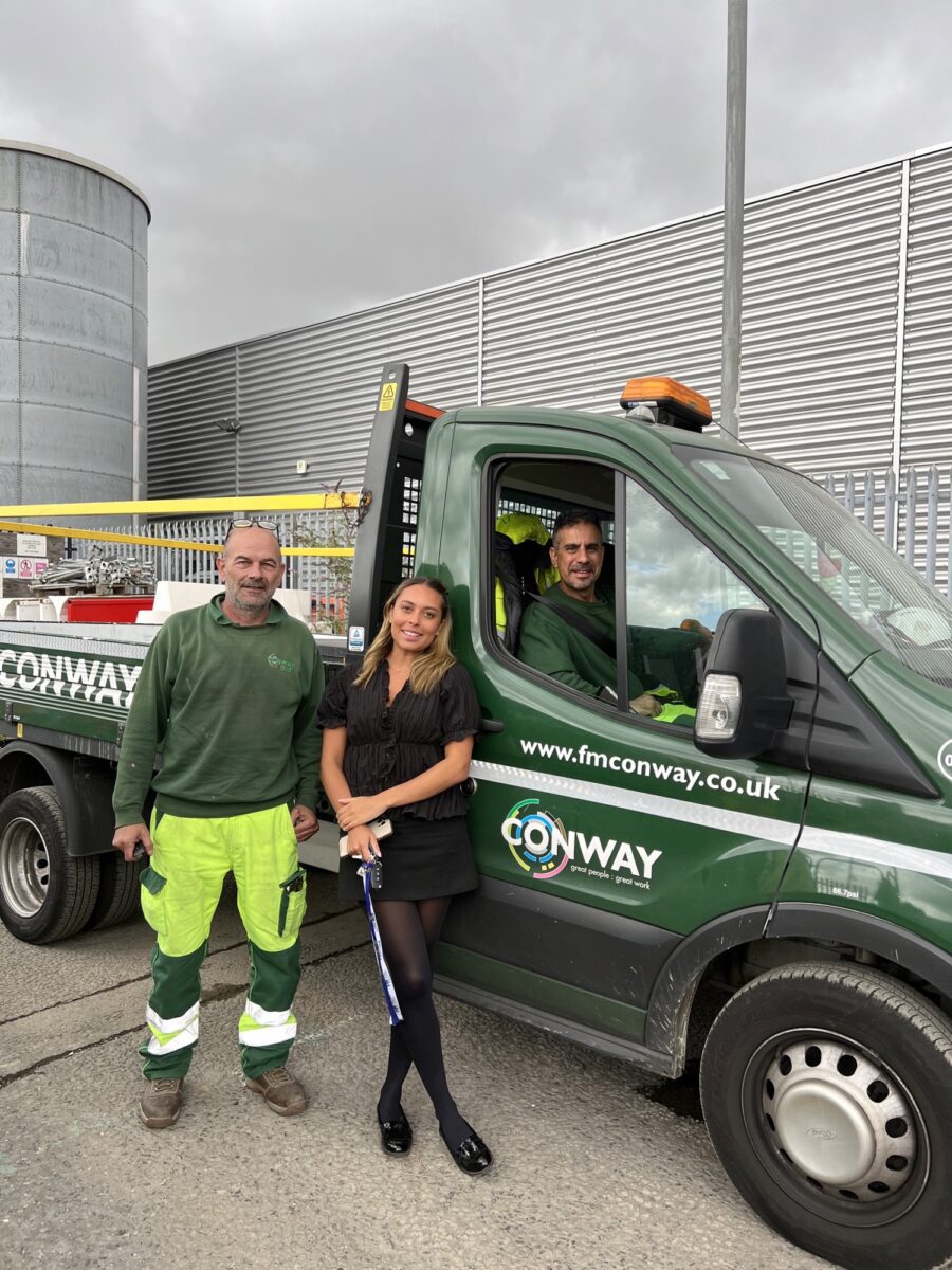 Jodie stood with colleagues, next to a van.