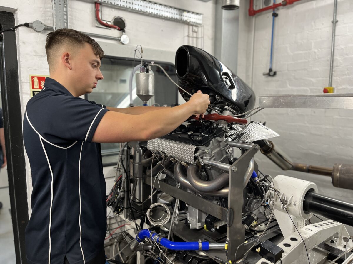 Jack fixing a propulsion system, using handheld tools.
