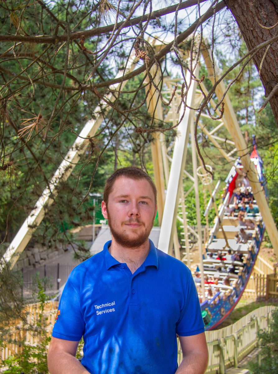Tommy posing in front of a pirate ship ride at Chessington World of Adventures.