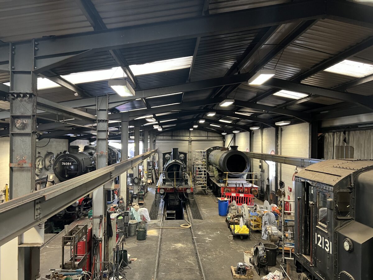 Train repair shed, containing several locomotives in various stages of repair.