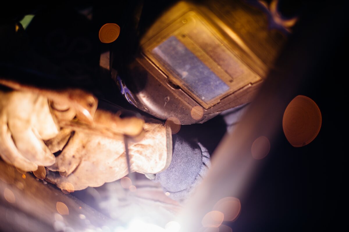 Isaac welding, wearing a face plate.