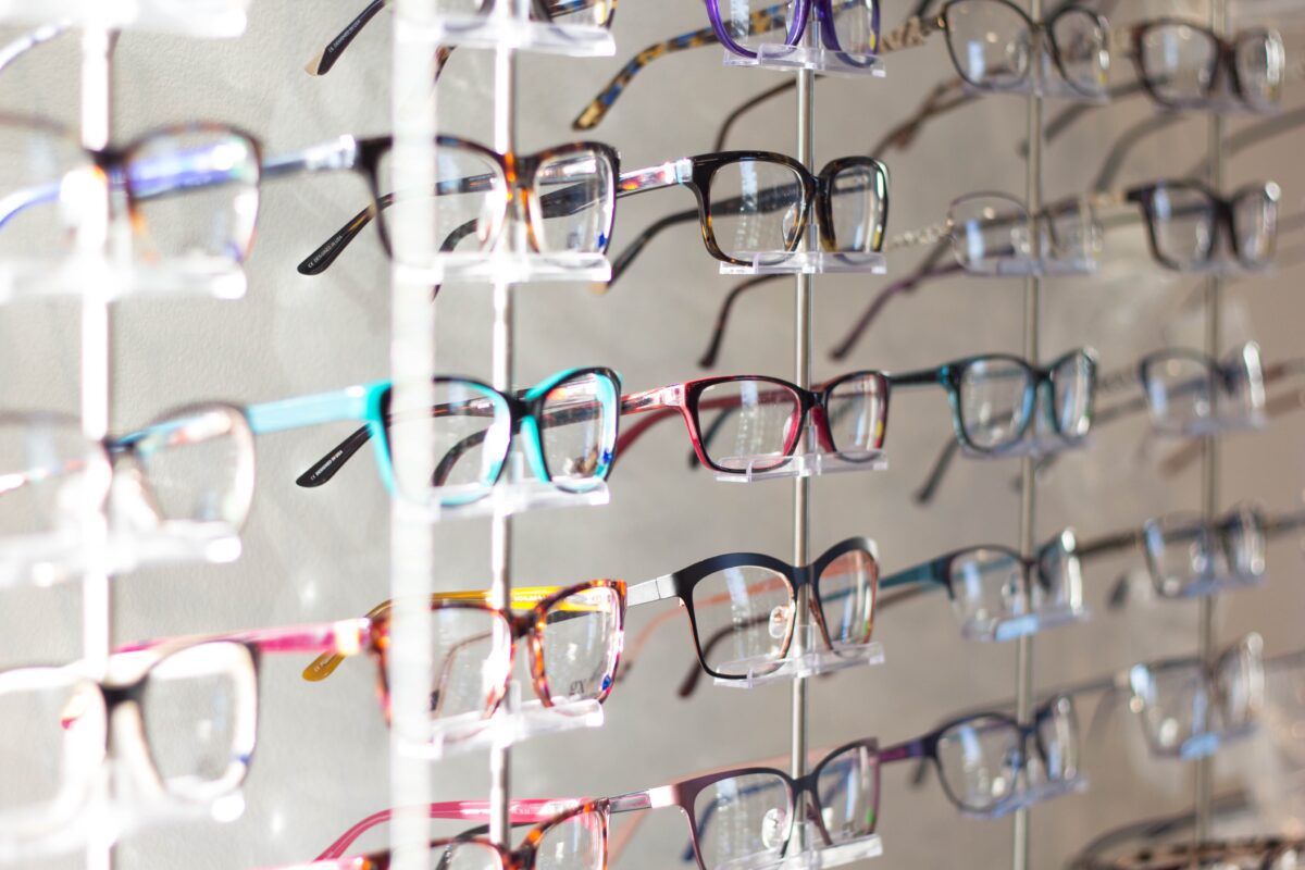Rows of spectacle frames on display at an opticians.