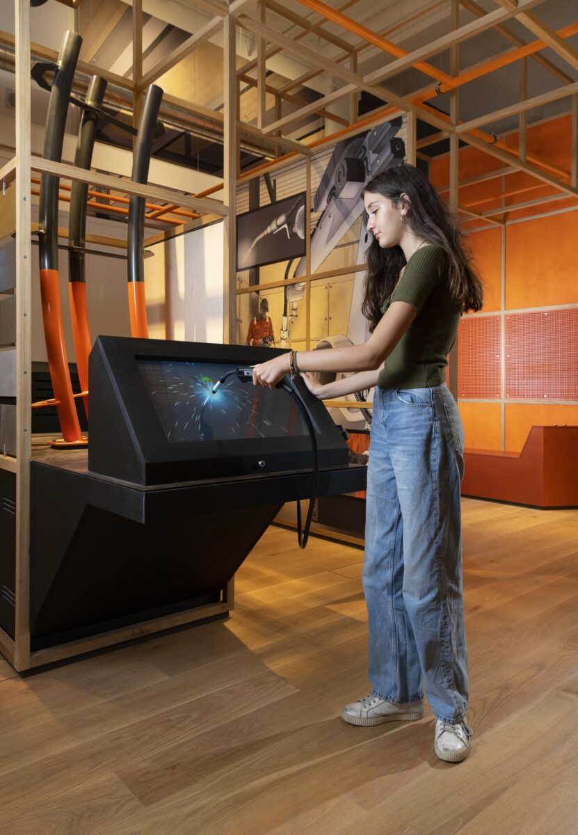 A visitor having a go at an interactive exhibit, at the Science Museum.