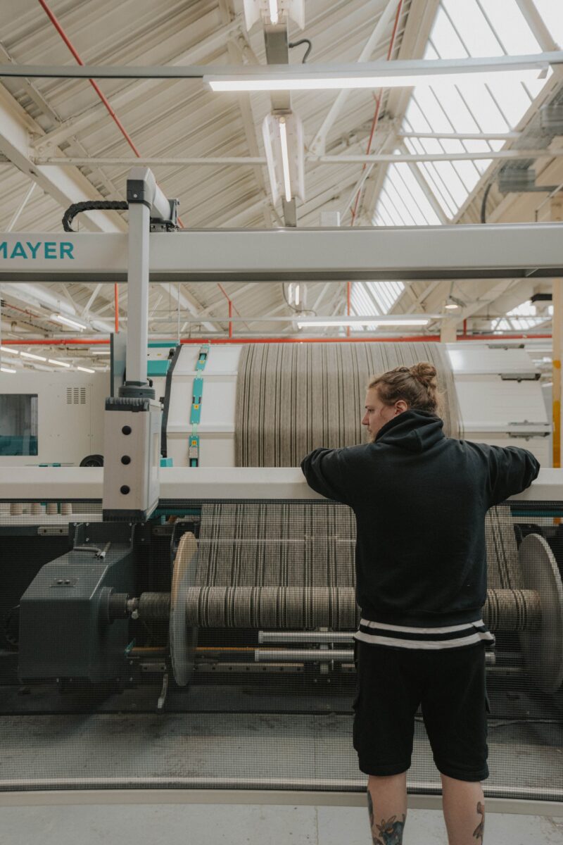 Jacob overseeing an industrial textile mill in operation.