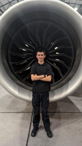 George standing in front of a jet engine.