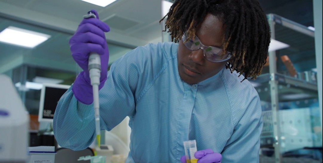 Toluwani holding a large pipette