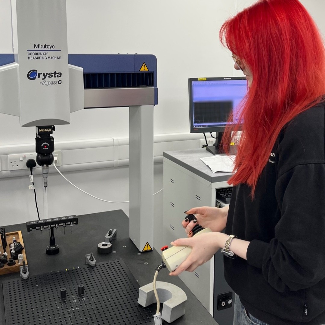 Imogen handling equipment on a tabletop in the lab.