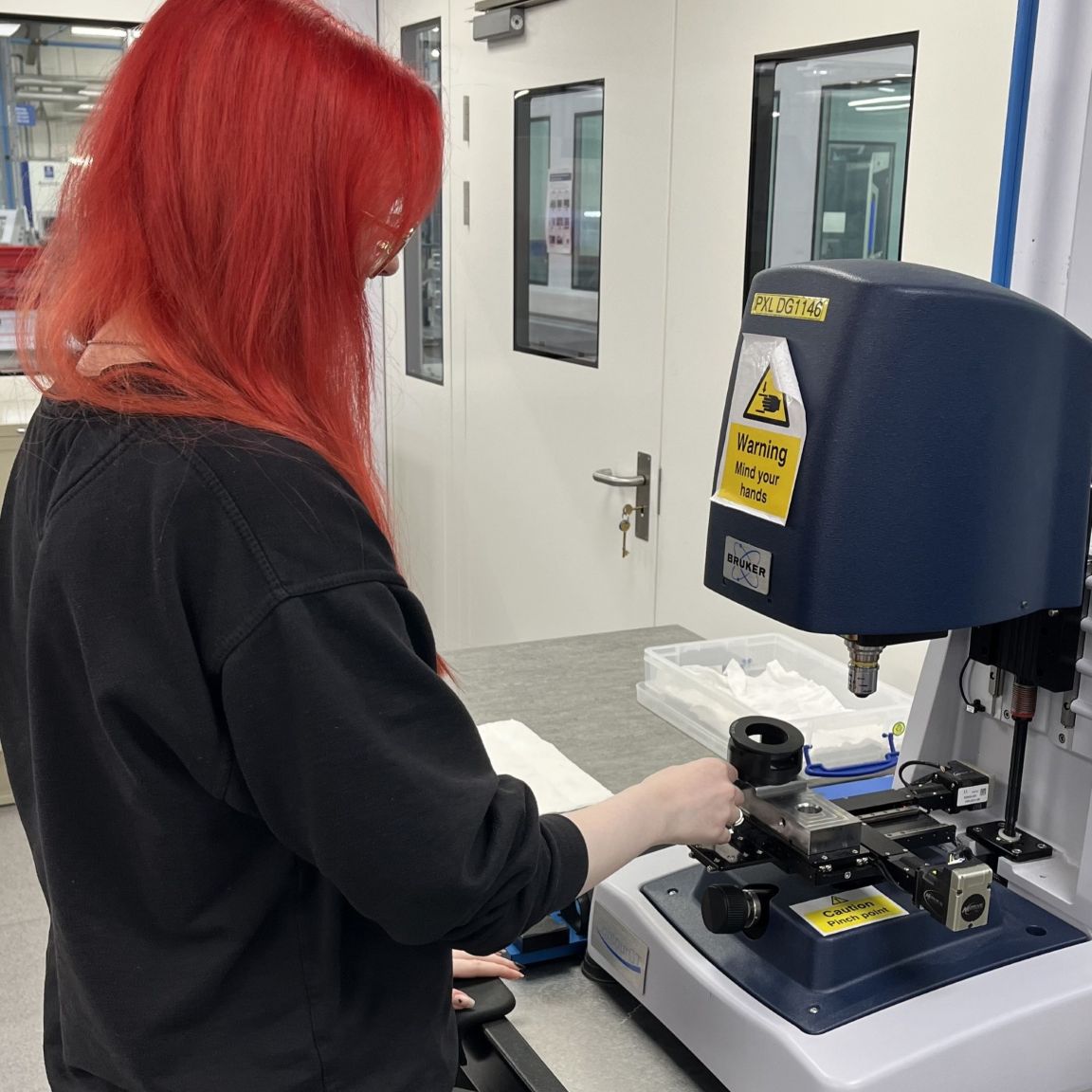 Imogen calibrating a piece of equipment in the lab.