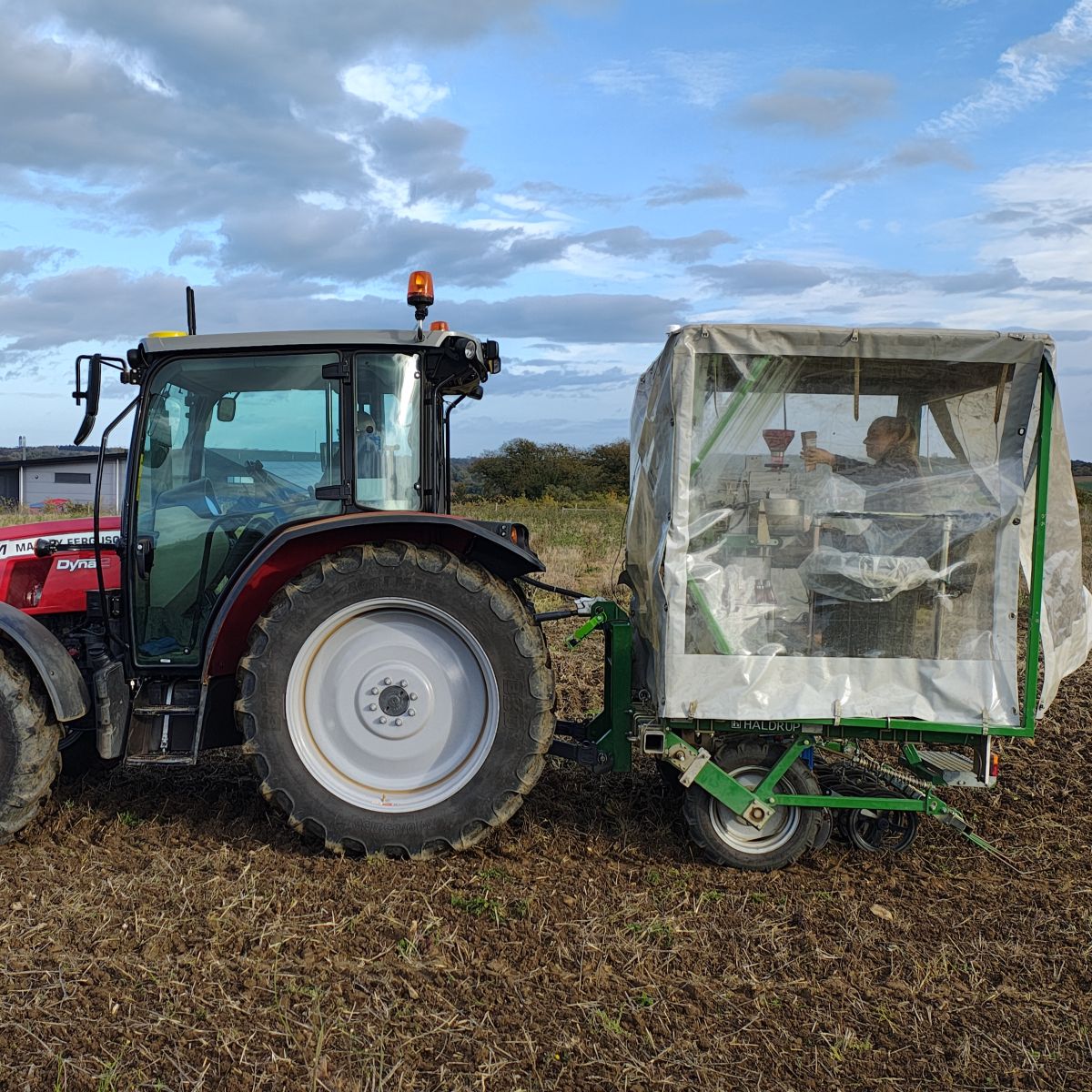 Rebecca testing a sample in a mobile lab, in a trailer on the back of a tractor.