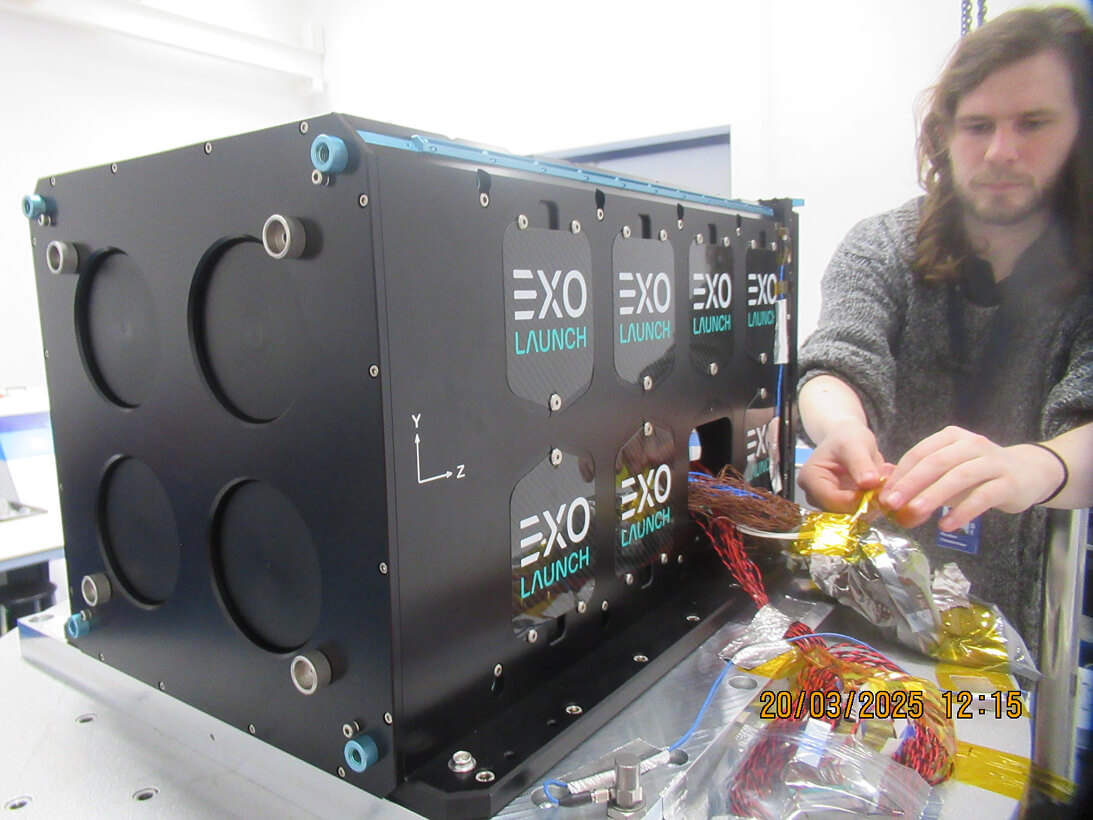 Reuben working with the wires in a piece of equipment