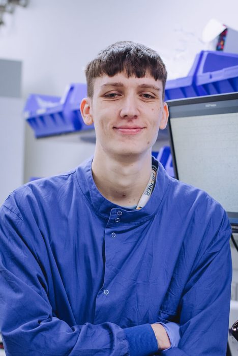 A picture of a man facing the camera wearing a blu uniform and basic PPE