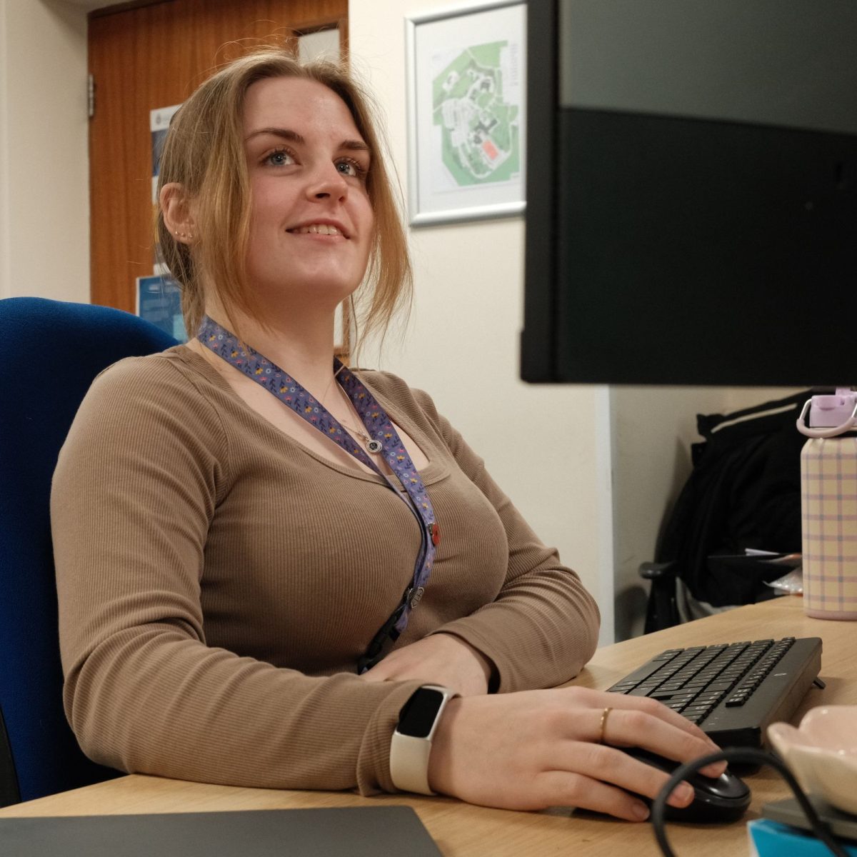 Digital Forensic Technician Elisha, sat at her desk in the office.