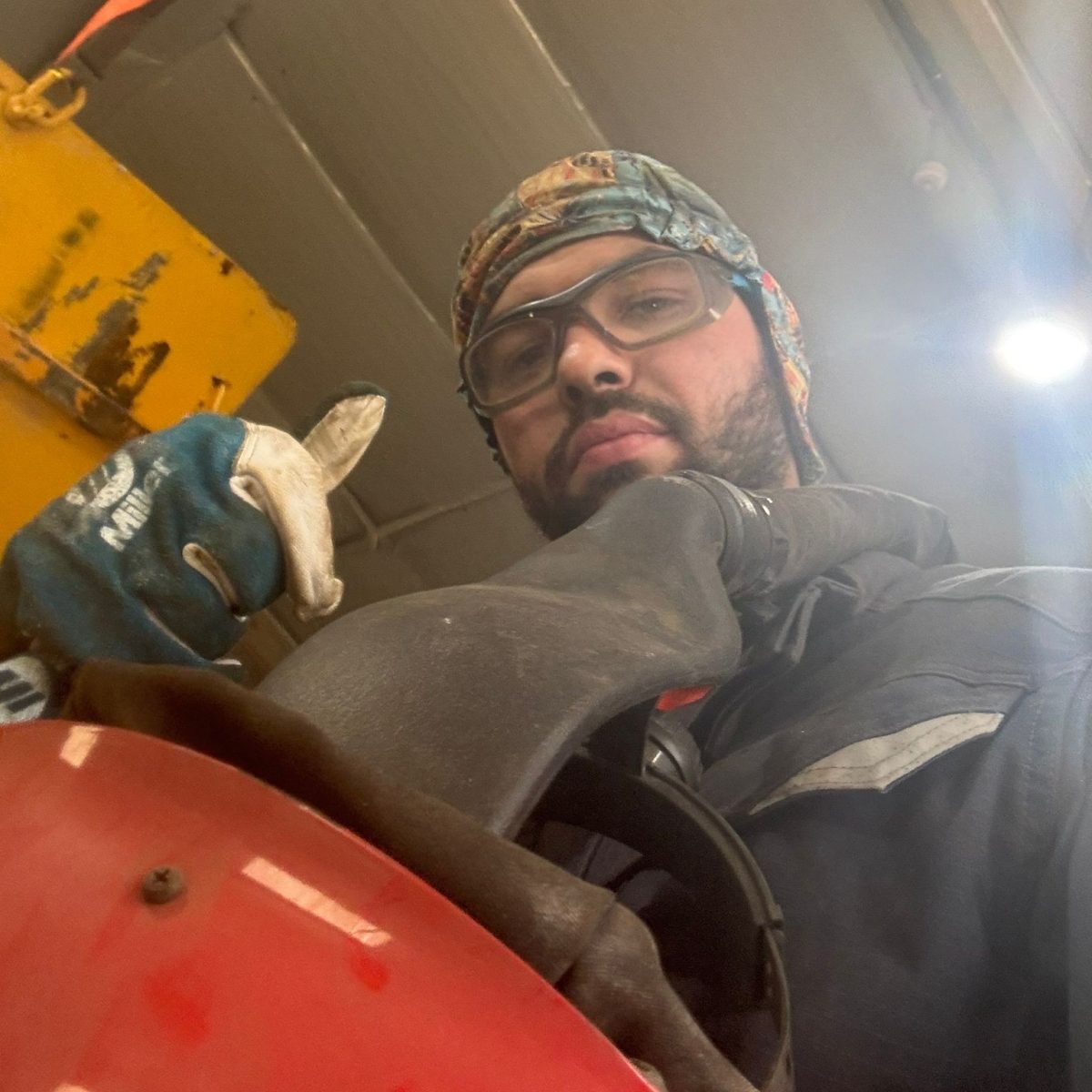 Land Based Engineering Technician Finn, wearing protective glasses and gloves, giving a thumbs up to the camera.