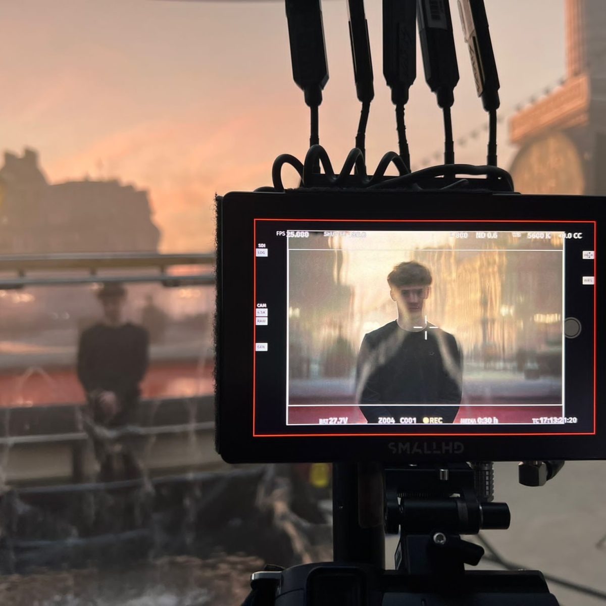 Special Effects Technician Lenny, seen through the screen of a digital camera, on a film set.