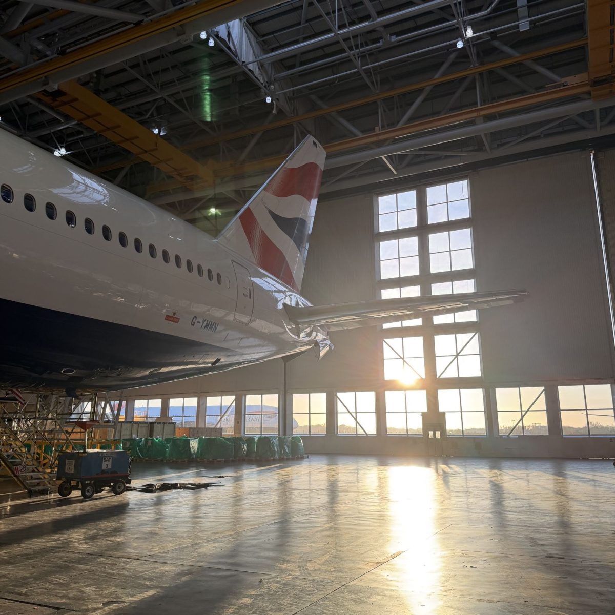 The tail of an aircraft in a hangar.